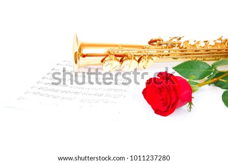 Musical notes and saxophone with red rose
