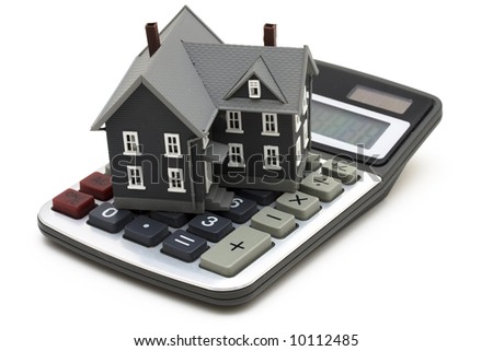 House sitting on calculator isolated on white Royalty-Free Stock Photo #10112485