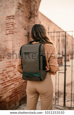 Young female tourist with a backpack in the Muslim city