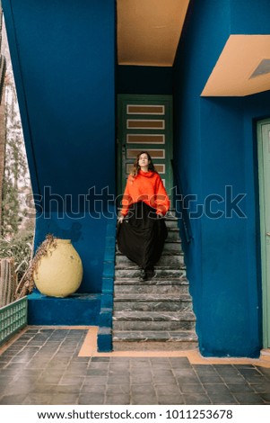 Young woman walking down the stairs of a nice house