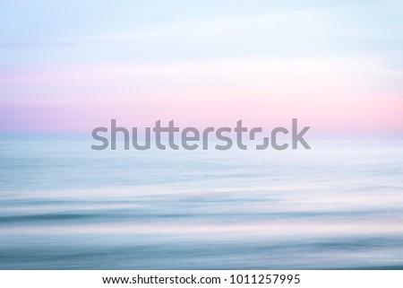 Abstract sunset sky and  ocean nature background with blurred panning motion. Royalty-Free Stock Photo #1011257995