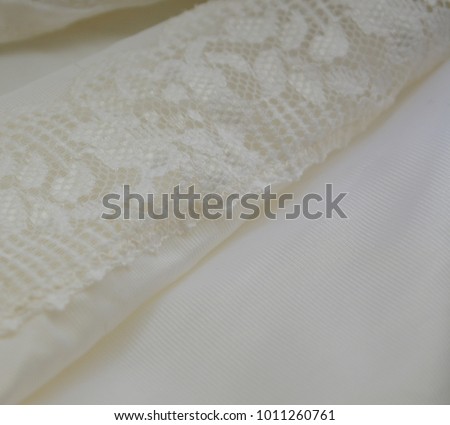 white satin with lace. tender romantic background.wedding texture