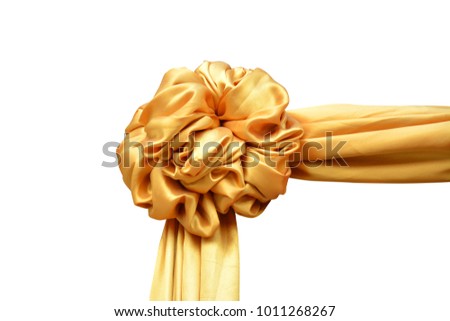 Gold cloth flower on a white background.