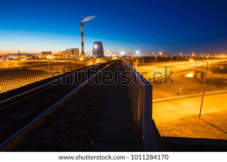 railroad to power plant. power plant at night.