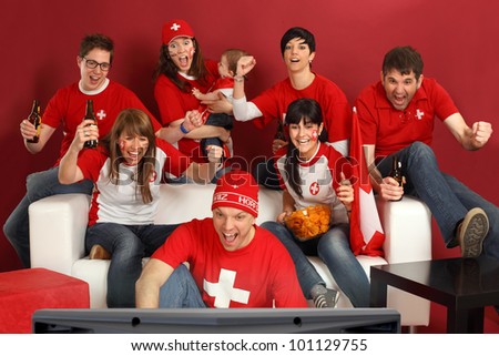 Photo of Swiss sports fans watching television and cheering for their team. Hopp Schwiiz!