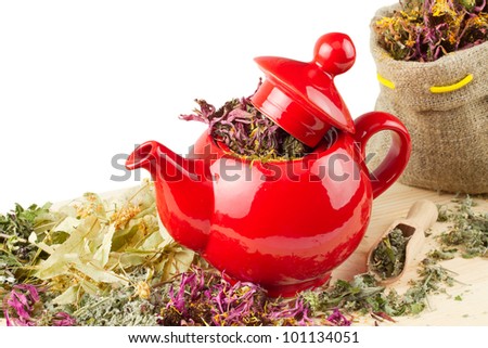 red teapot, mortar and pestle, sack with healing herbs, alternative medicine