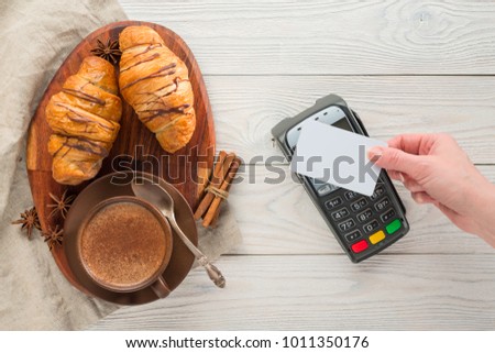 payment through the NFC technology terminal for purchase in a cafe