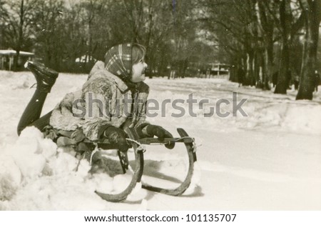Vintage photo of little girl on sled (fifties)