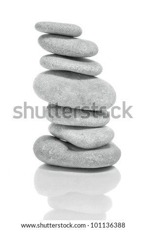 a pile of zen stones on a white background