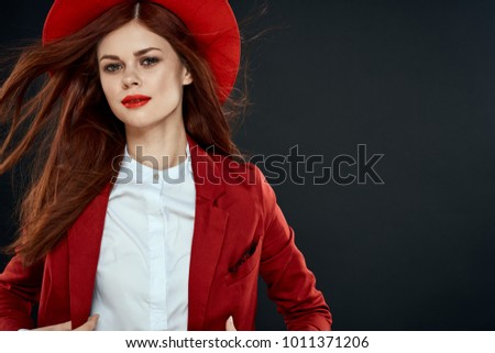   pretty woman in a hat with red lips on a black background                             