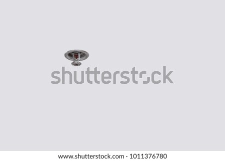 Smoke detector and pendent fire sprinkler on a ceiling,fire emergency
