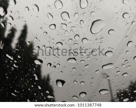 Raindrops on a mirror car.