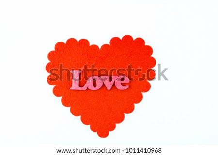 Red heart with the word \love\ pink letters isolated on a white background.
