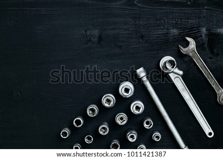 Tools for car repair in Workshop. Car repair equipment on black wooden background in car repair shop