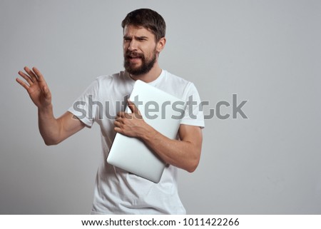  man with a tablet on a gray background                              
