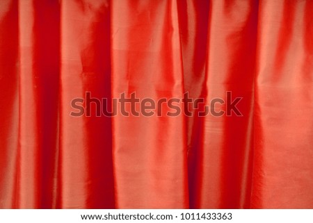 Red silk textured cloth background,Closeup of rippled satin fabric with soft waves.