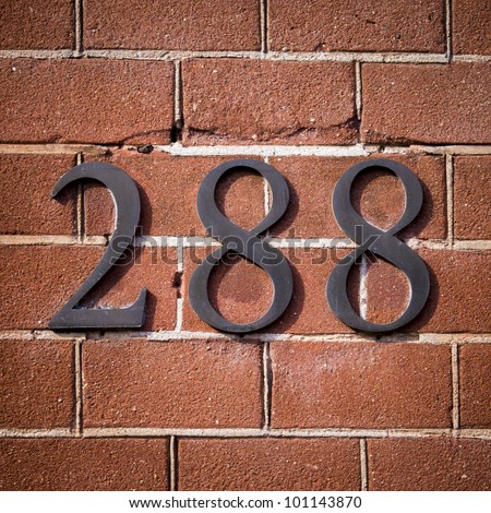 bronze house number two hundred eighty-eight on a red brick wall