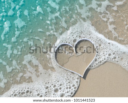 Heart shape on soft waves and sand background , concept  for Valentines Day