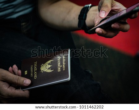 Thailand Passport For Travel,Hands male with smartphone.