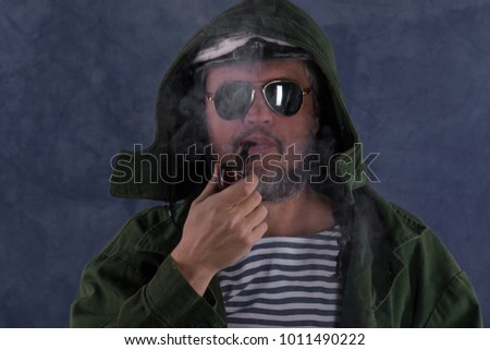 the captain of a ship smokes a pipe