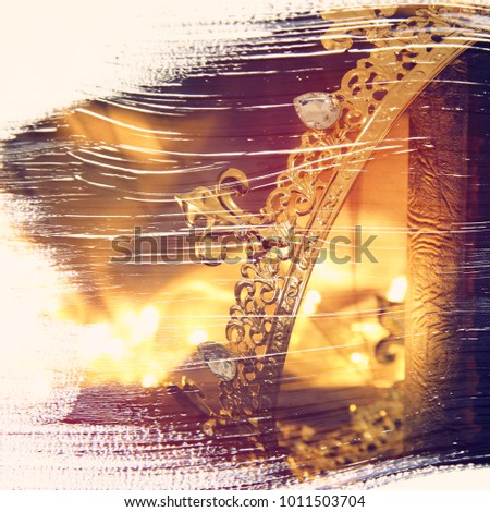 abstract image of of beautiful queen/king crown on old book. fantasy medieval period. double exposure effect