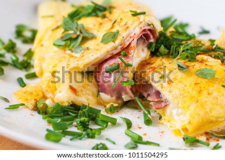 Egg omelette with ham and cheese with chive, closeup. Royalty-Free Stock Photo #1011504295