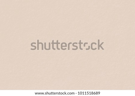Paper texture light rough textured spotted blank copy space background in beige, yellow, brown. High resolution photo.