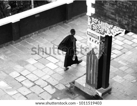 tibetan monk walking black and white