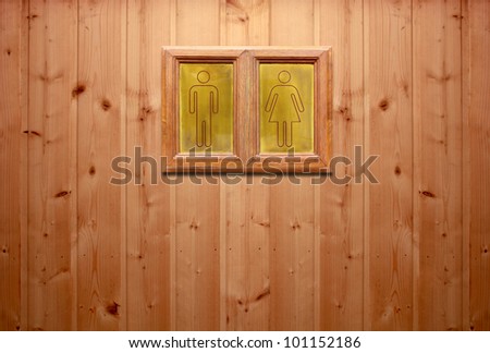 wooden sign for Man & Woman restroom on wooden wall