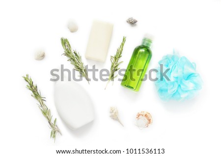 White shampoo bottle, baby soap, rosemary herbs, green essential oil, blue spobge and seashells. Natural organic bath products. Bathroom items. Flat lay stock photo for web site and beauty blog
