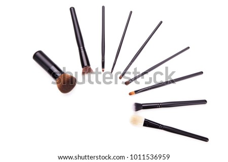 Various makeup brushes isolated over white background,Flat top view set of essential professional make-up brushes on white background. Copy space for your text.
