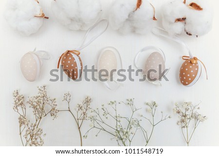 Easter decoration with eggs, cotton and White Flowers on a rustic white wooden background. Easter concept. Flat lay. Spring greeting card