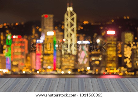 Opening wooden floor, Night blurred bokeh light Hong Kong city business downtown, abstract background