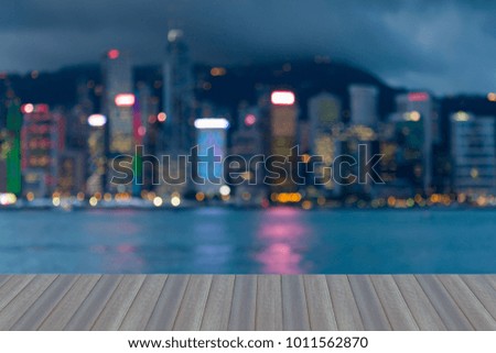 Opening wooden floor, City night blurred bokeh light Hong Kong business downtown, abstract background