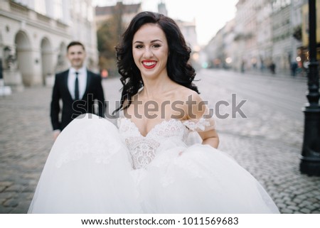 Bride and groom walking through the old town