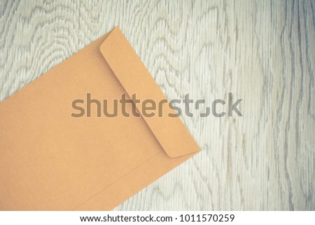 Envelope on wood background.