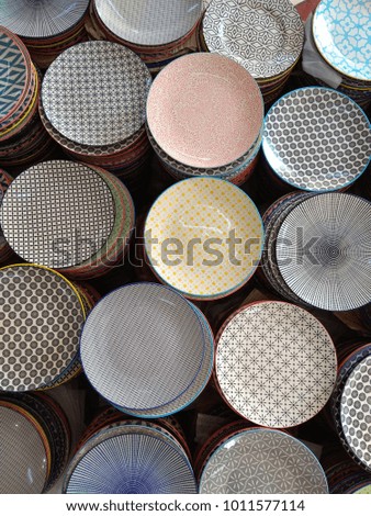 Various design ceramic bowls in different colors stacked together at the stall, top view