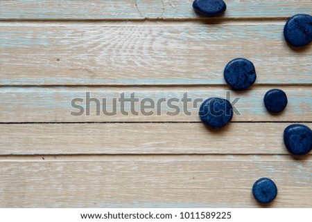 Blue decorative stones on a wooden background.
