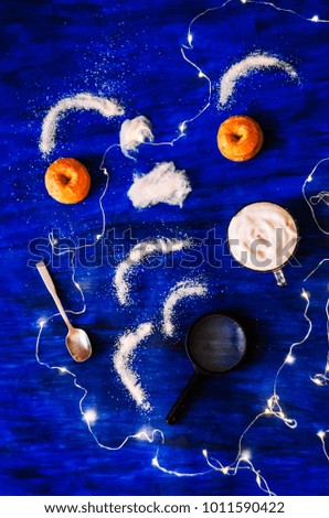 Coffee with milk, magic
Top view, blue background