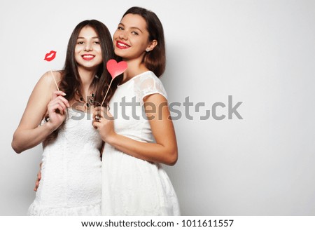life style and people concept: two stylish sexygirls best friends ready for party, over white  background
