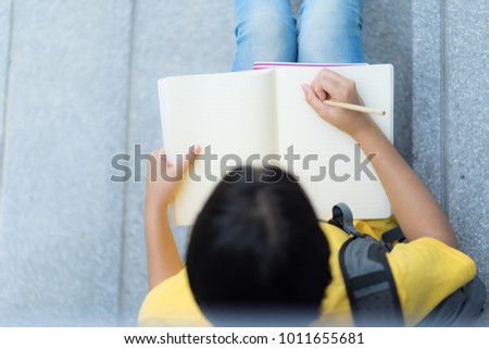 College asian student female sitting on staircase