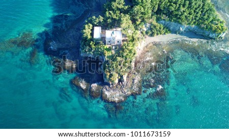 Aerial drone photo of tropical island with lighthouse and turquoise clear waters