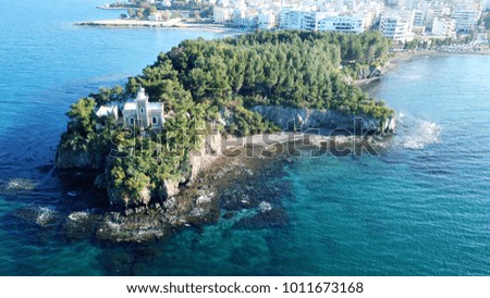 Aerial drone photo of tropical island with lighthouse and turquoise clear waters
