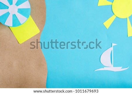 Summer background with sailboat sailing in the sea, beach umbrella and mat. Paper cut.