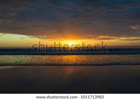 Sunrise over Embleton Bay beach, Northumberland, UK. Beautiful morning sky seascape