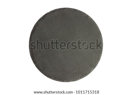 Black slay tray for food on the white background. Round rustic black slate stone plate.