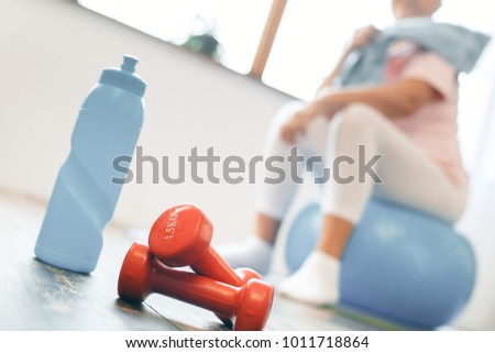 Senior woman exercise at home sitting on exercise ball close-up