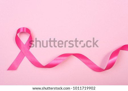 pink ribbon breast cancer on pink background. with copy space Royalty-Free Stock Photo #1011719902