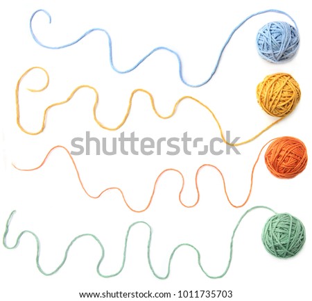 Colorful cotton thread balls isolated on white background. Set of four color (orange, yellow, green, blue) thread balls. Royalty-Free Stock Photo #1011735703