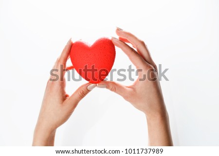 heart in ladon female hands on white background, symbol of support. hope and love
